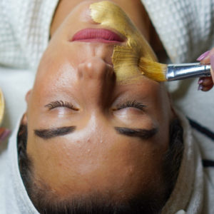 application of exfoliating mask with milk and honey on the skin